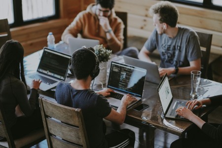Engineering team working at laptops in an open-plan office